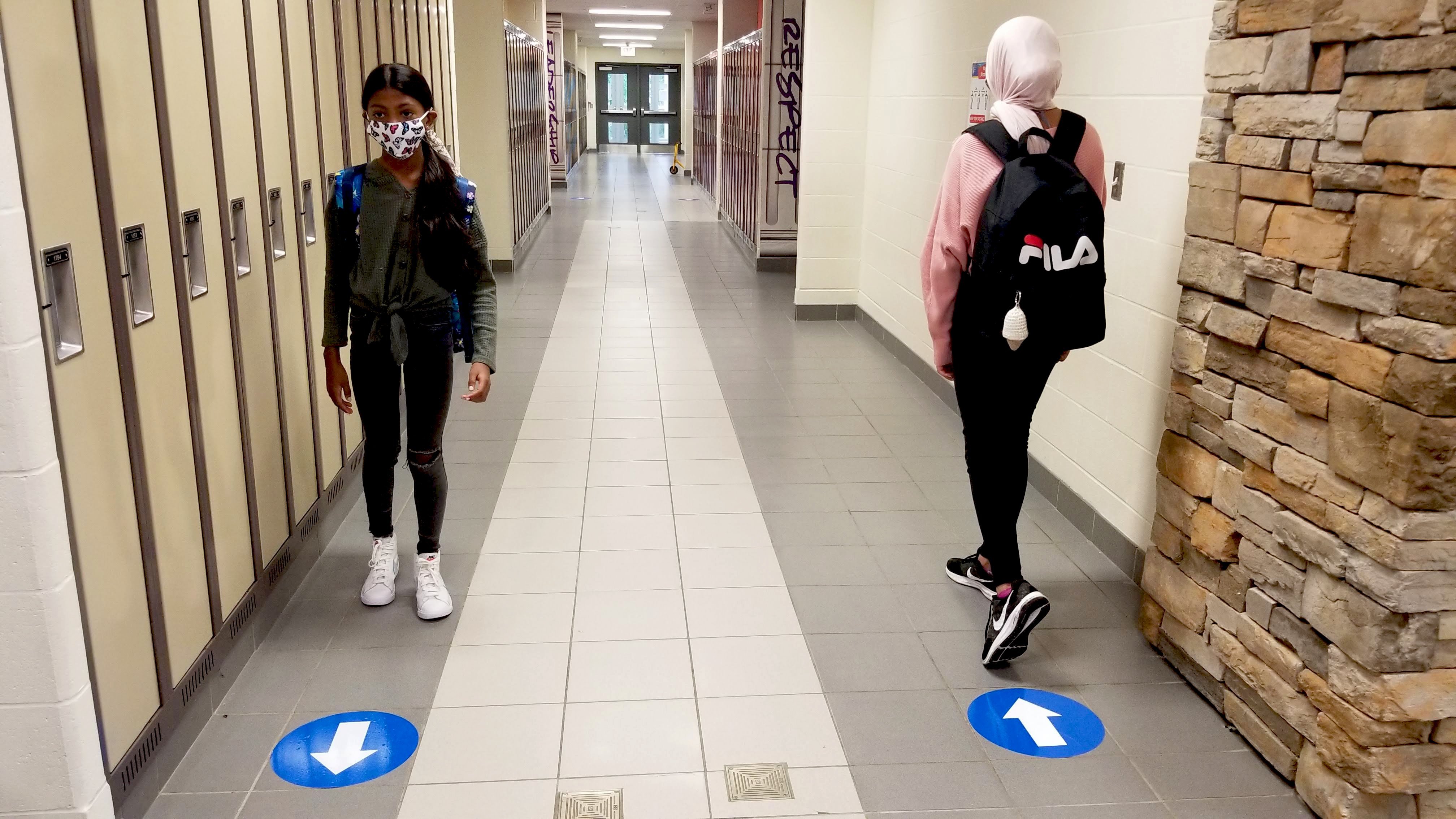 students in hall with masks